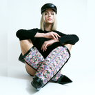 Woman with baker boy cap in black and Yve boots in black with shaft in artificial design